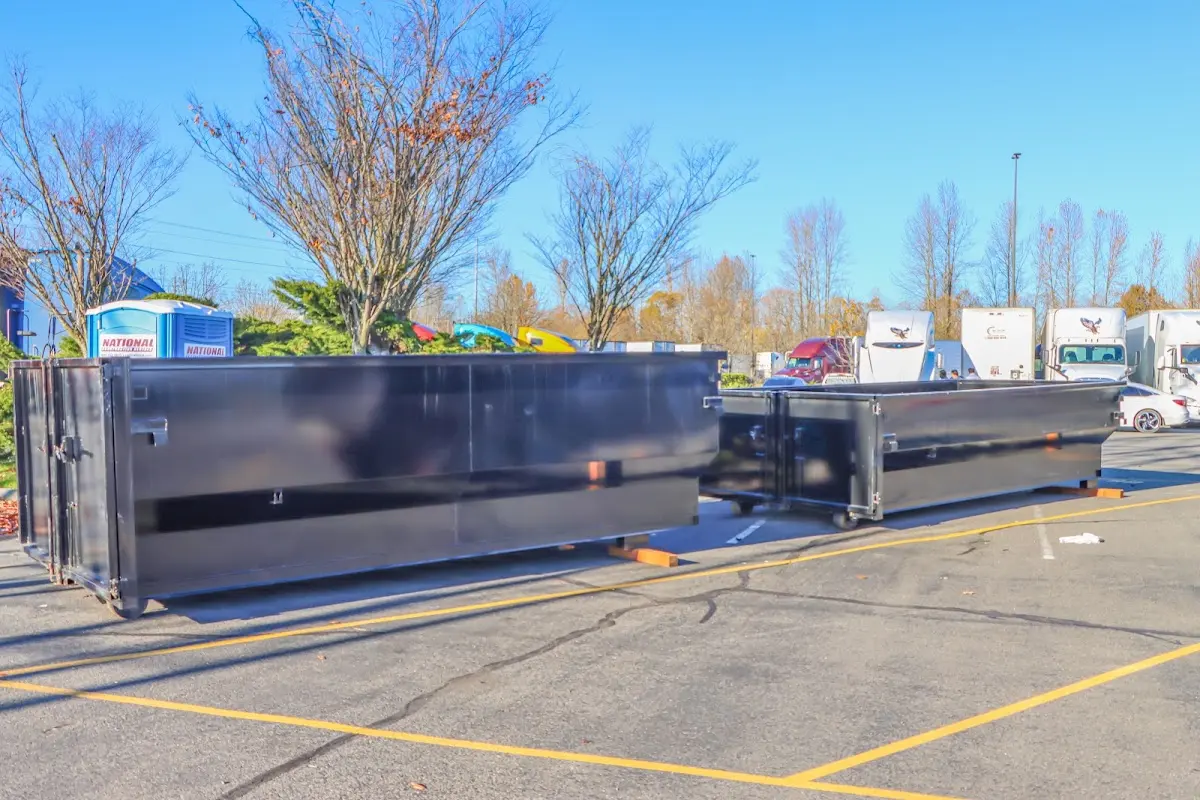 Professional dumpster rental service with roll-off container on residential driveway in Inglewood